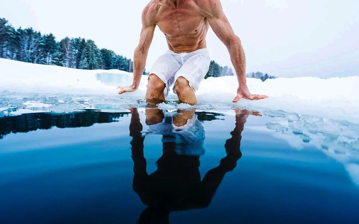 Man taking ice plunge into ice water